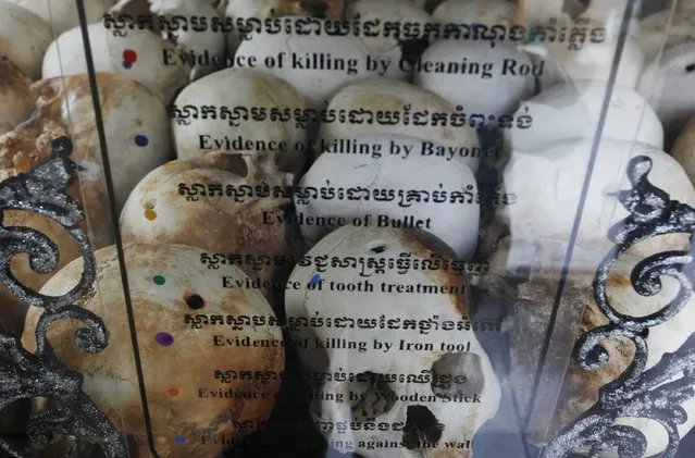 Skulls and bones of more than 8,000 victims of the Khmer Rouge regime are displayed at Choeung Ek, a “Killing Fields” site located on the outskirts of Phnom Penh April 17, 2015. (Photo by Samrang Pring/Reuters)