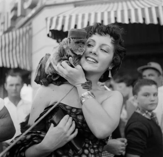 Actress Kathleen Case poses with a monkey during the Opening day of Disneyland in Anaheim,California, 1955. (Photo by Earl Leaf/Michael Ochs Archives/Getty Images) 