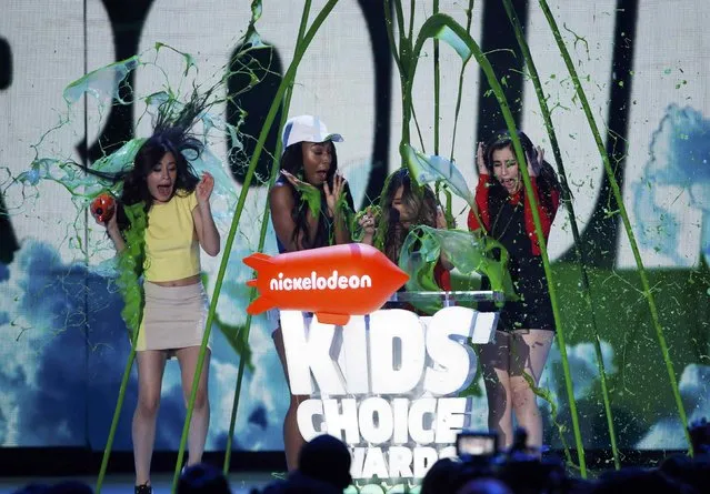 The group Fifth Harmony is “slimed” while accepting the award for Favorite Music Group during Nickelodeon's 2016 Kids' Choice Awards in Inglewood, California March 12, 2016. (Photo by Mario Anzuoni/Reuters)
