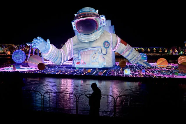 A man visits a new year's fair in Beijing on February 4, 2024. (Photo by Pedro Pardo/AFP Photo)