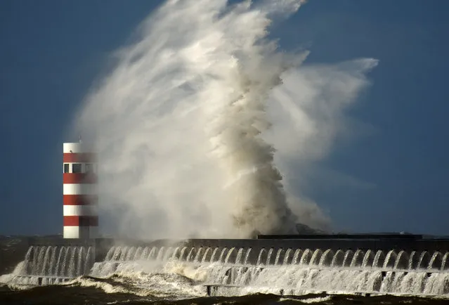 Rough waves pound the pier at Douro's river mouth in Porto, Portugal, Monday February 10, 2014. The Portuguese weather institute put the entire coast of Portugal on red alert, the most serious in a scale of four, due to rough seas and gale force winds as storm Stephanie moves in. (Photo by Paulo Duarte/AP Photo)