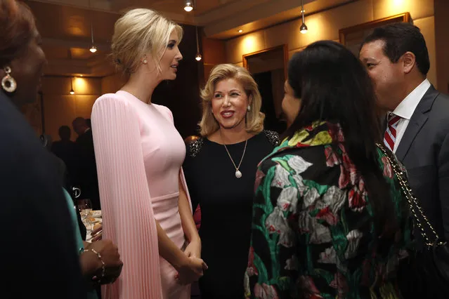 U.S. White House senior adviser Ivanka Trump, left, speaks with wife of Ivory Coast's President Alassane Ouattara, Dominique Ouattara, center, and other attendees at a State Dinner hosted by Ouattara after the Women Entrepreneurs Finance Initative, or We-Fi, event, Wednesday April 17, 2019, in Abidjan, Ivory Coast, where Trump is promoting a White House global economic program for women. (Photo by Jacquelyn Martin/AP Photo)
