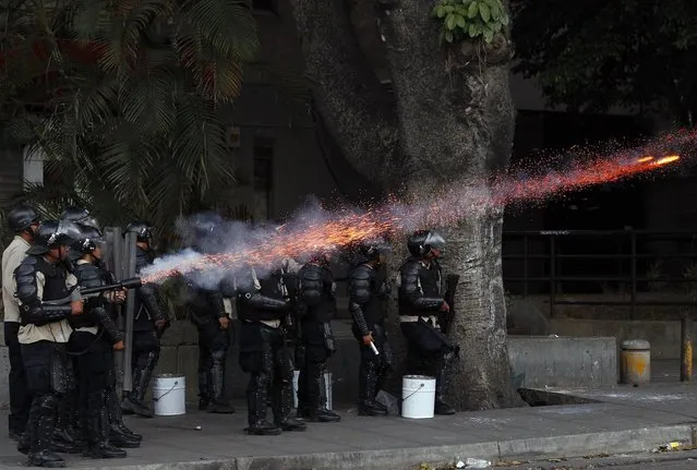 Police fire tear gas at anti-government protesters at Altamira square in Caracas March 6, 2014. (Photo by Carlos Garcia Rawlins/Reuters)