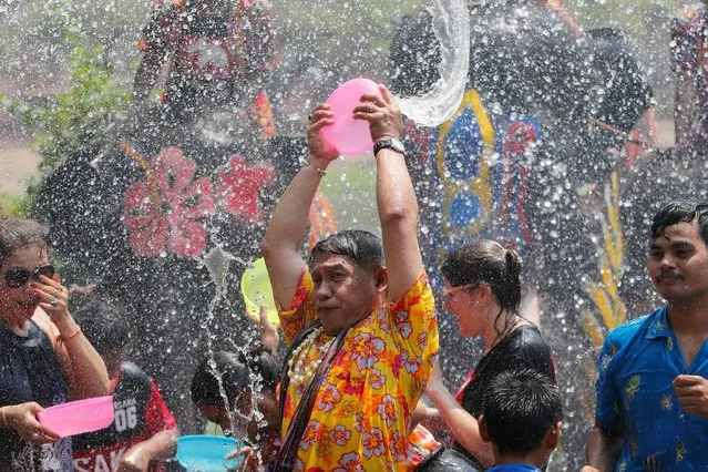 People and elephants splash each other with water during the celebration of the Songkran water festival in Thailand's Ayutthaya province, north of Bangkok, April 11, 2016. (Photo by Jorge Silva/Reuters)