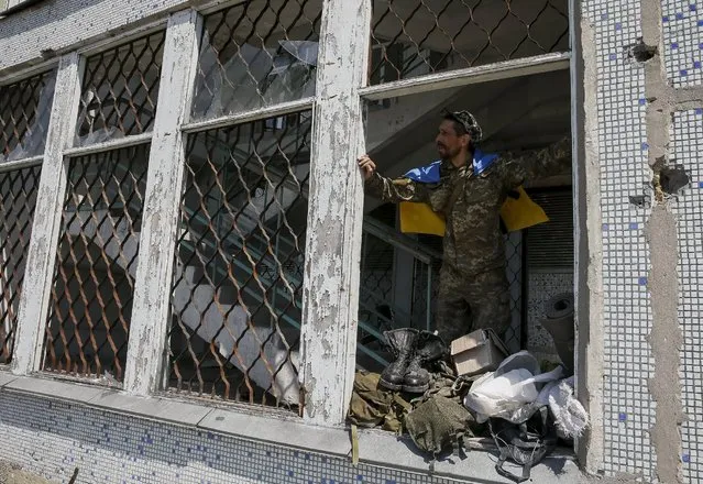 A member of the Ukrainian armed forces is seen in the town of Maryinka, eastern Ukraine, June 5, 2015. Ukraine's president told his military on Thursday to prepare for a possible "full-scale invasion" by Russia all along their joint border, a day after the worst fighting with Russian-backed separatists in months.  REUTERS/Gleb Garanich
