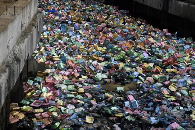 A dump of used foam takeout food containers floats and blocks a drainage points following a heavy storms in Lagos, on June 26, 2019. Lagos State Governor Babjide Sanwo-Olu, recently has declared a state of emergency on environmental sanitation and traffic management matters to check the resurgence of waste in the metropolis, environmental abuse, including illegal and indiscriminate dumping of refuse, especially on drainage points which mostly are responsible for flooding during raining reason. (Photo by Pius Utomi Ekpei/AFP Photo)