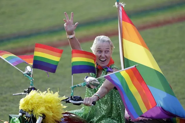 A participant rides a motorcycle in the Gay and Lesbian Mardi Gras parade at the Sydney Cricket Ground in Sydney, Saturday, March 6, 2021. The annual event has been forced into a sport stadium due to COVID-19 restrictions. (Photo by Rick Rycroft/AP Photo)