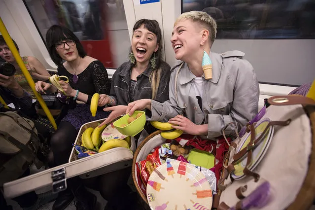 Women eat on a Circle Line Underground train in protest at the “Women who eat on tubes” website on April 14, 2014 in London, England. The “Women who eat on tubes” blog invites members of the public to upload images of women eating on the London Underground and  has received thousands of followers plus numerous accusations of misogyny. (Photo by Oli Scarff/Getty Images)