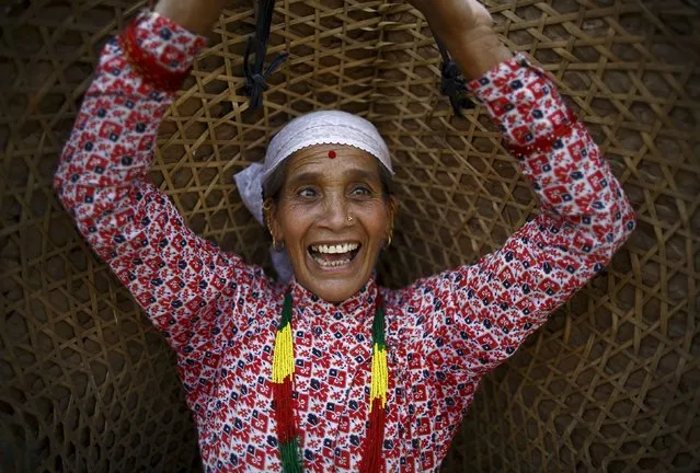 A woman smiles as she takes part during the Asar Pandhra festival in Pokhara valley, west of Nepal's capital Kathmandu, June 30, 2015. (Photo by Navesh Chitrakar/Reuters)