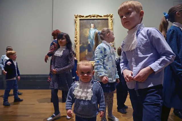 Children walk in front of Thomas Gainsborough artwork “The Blue Boy” on its centenary comeback to the UK, at The National Gallery in London, Britain, January 24, 2022. (Photo by Hannah McKay/Reuters)