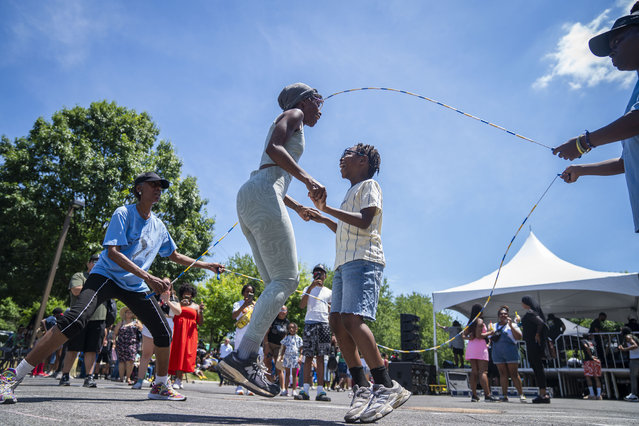 Ashley Buggs and her son, Ezrah White, jump rope at the annual Juneteenth Freedom Celebration at the Anacostia Community Museum in Washington on June 19, 2024. (Photo by Allison Robbert/The Washington Post)
