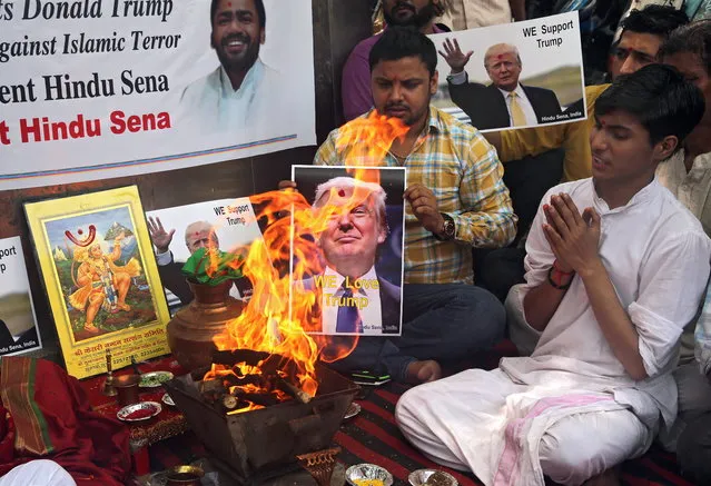 Indian activists from the right-wing organisation Hindu Sena perform Hindu fire rituals in support of US Republicans presidential candidate Donald Trump in New Delhi, India, 11 May 2016. Right-wing organisation Hindu Sena activists prayed to the Hindu gods and performed rituals to ensure the victory of Donald Trump in US Presidential elections and urged the Indian origin people living in USA to vote and support him. (Photo by Rajat Gupta/EPA)