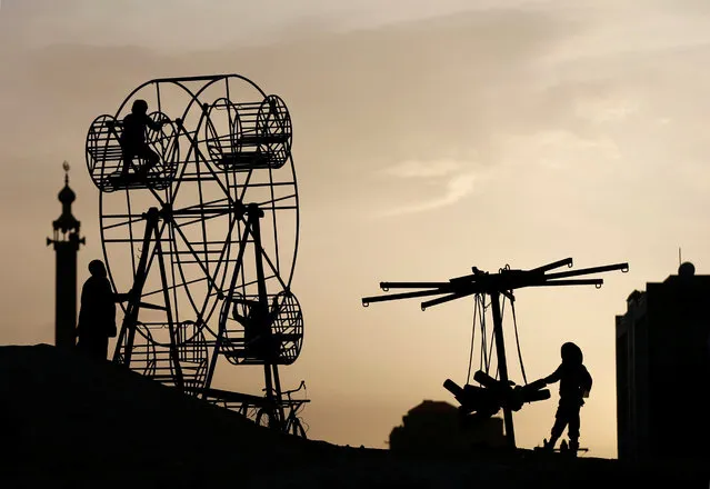 Afghan children play on a manually operated ferris wheel in Kabul, Afghanistan April 11, 2017. (Photo by Mohammad Ismail/Reuters)