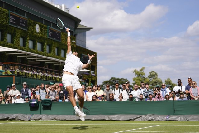 Lorenzo Musetti plays a forehand return to compatriot Luciano Darderi during their second round match at the Wimbledon tennis championships in London, Thursday, July 4, 2024. (Photo by Alberto Pezzali/AP Photo)