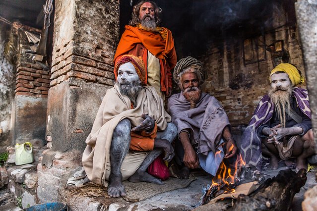 On a chilly morning at the Pashupatinath Temple, on the outskirts of Kathmandu, sadhus keep warm by the fire. (Photo by Amy Sinead Moran/GuardianWitness)