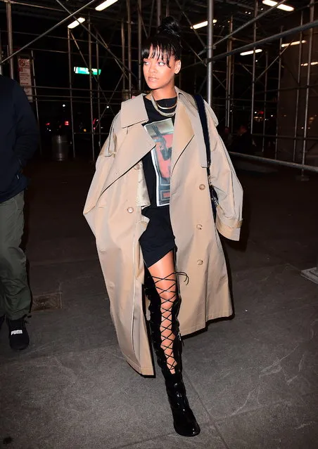 Rihanna showed up to a Business meeting looking mysterious in a Giant Oversized Trench coat on Wednesday in NYC on May 3, 2017. She hit her perfect figure underneath the large coat, but showed off her long legs in waist high patent leather lace up boots. She paired the look with a SCARFACE Al Pacino T Shirt, Gold Cuban link Chains, and a large Christian Dior Tote bag. (Photo by 247PAPS.TV/Splash News and Pictures)