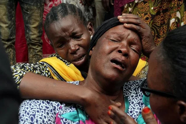 Relatives mourn their dead kin outside the Morogoro referral hospital, after a fuel tanker exploded killing a crowd of people collecting liquid from puddles in jerry cans in Morogoro, eastern Tanzania on August 11, 2019. (Photo by Emmanuel Herman/Reuters)