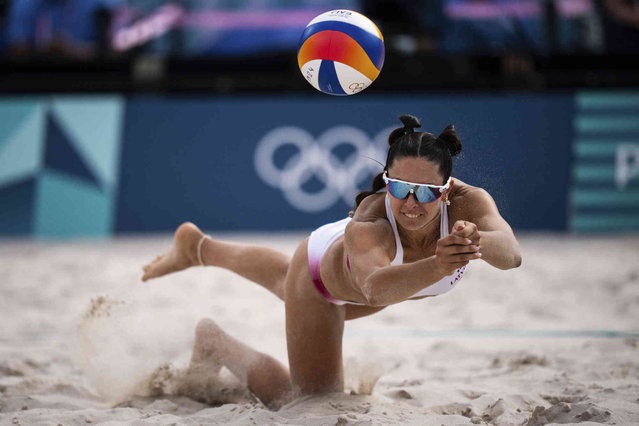 Latvia's Anastasija Samoilova dives for the ball during the women's pool D beach volleyball match between Canada and Latvia at Eiffel Tower Stadium at the 2024 Summer Olympics, Saturday, August 3, 2024, in Paris, France. (Photo by Louise Delmotte/AP Photo)