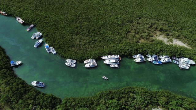 A drone view shows yachts anchored near mangrove to protect them from the storm surge, ahead of the arrival of Hurricane Beryl, at the Nichupte lagoon, in Cancun, Mexico on July 4, 2024. (Photo by Paola Chiomante/Reuters)