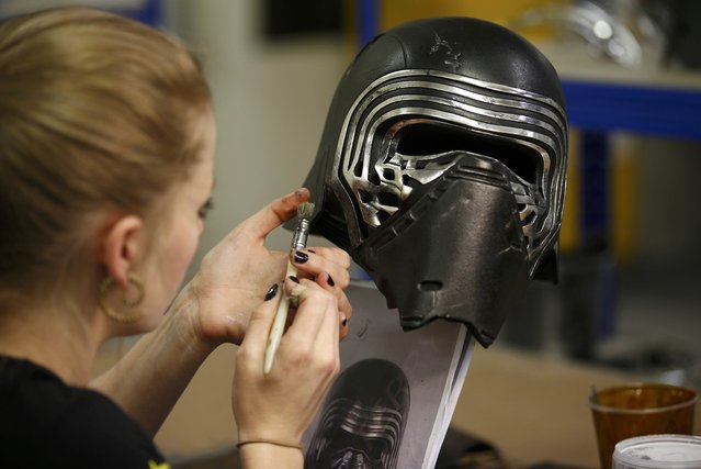 A technician adds finishing touches to a replica of Kylo Ren's helmet from “Star Wars: The Force Awakens”, in the Propshop headquarters at Pinewood Studios near London, Britain May 25, 2016. (Photo by Peter Nicholls/Reuters)