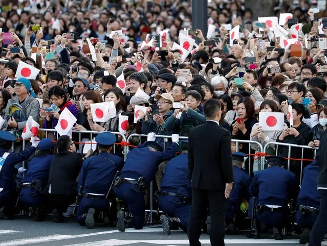 Well-wishers watch the royal parade to mark the enthronement of Japanese Emperor Naruhito in Tokyo, Japan, November 10, 2019. (Photo by Issei Kato/Reuters)