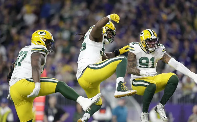 Green Bay Packers' Kenny Clark, left, Za'Darius Smith and Preston Smith, right, celebrate after a sack during the first half of the team's NFL football game against the Minnesota Vikings, Monday, December 23, 2019, in Minneapolis. (Photo by Andy Clayton-King/AP Photo)