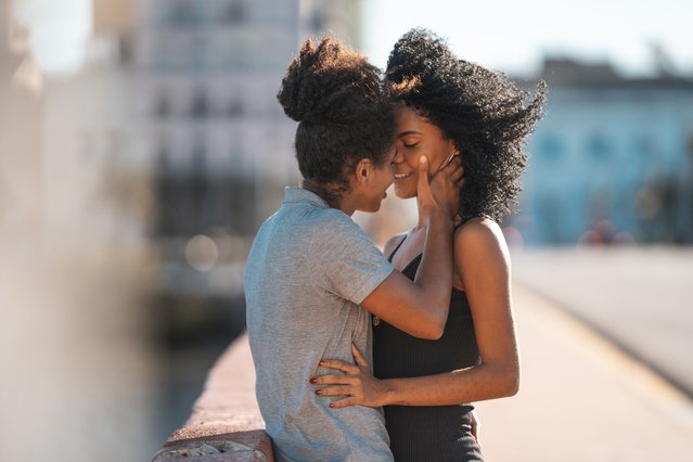 Lesbian couple kissing on the mouth outdoors in Brazil. (Photo by Mesquita FMS/Getty Images)