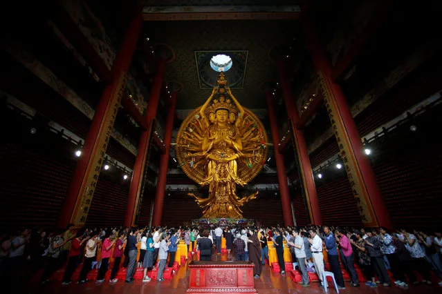 Families participate at a ceremony to pray for the students taking China's annual National College Entrance Exam which finishes today at Donglin Temple in Shanghai, China June 8, 2016. (Photo by Aly Song/Reuters)