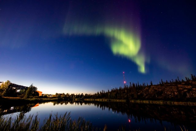 The northern lights, or the aurora borealis, appear in the sky over Rat Lake in Yellowknife, Northwest Territories on Thursday, August 8, 2024. (Photo by Bill Braden /The Canadian Press via AP Photo)