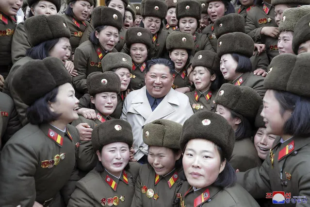 In this undated photo provided on Monday, November 25, 2019, by the North Korean government, North Korean leader Kim Jong Un, center, poses as he inspects a women's company under Unit 5492 of the Korean People's Army in North Korea. Independent journalists were not given access to cover the event depicted in this image distributed by the North Korean government. The content of this image is as provided and cannot be independently verified. Korean language watermark on image as provided by source reads: “KCNA” which is the abbreviation for Korean Central News Agency. (Photo by Korean Central News Agency/Korea News Service via AP Photo)