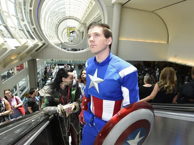 Matt Rogers, dressed as Captain America, rides the escalator up on day 1 of the 2014 Comic-Con International Convention held Thursday, July 24, 2014 in San Diego. (Photo by Denis Poroy/Invision/AP Photo)