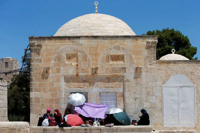 Palestinian women read the Koran on the last Friday of the holy fasting month of Ramadan on the compound known to Muslims as Noble Sanctuary and to Jews as Temple Mount in Jerusalem's Old City July 1, 2016. (Photo by Ammar Awad/Reuters)