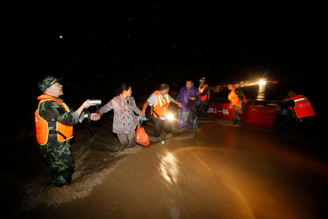 Rescuers save residents from a flooded area in Wuhan, Hubei Province, China, July 2, 2016. (Photo by Reuters/Stringer)