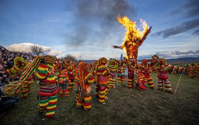 Revellers from the Portuguese village of Podence dressed in a traditional costume during annual Carnival festivities on February 25, 2020 in Macedo de Cavaleiros, Portugal. Revellers, known as 'Caretos' wear brass or wooden masks and dressed up in costumes made of dyed wool and with cowbells in their belts. Revellers shout and chase people in the streets to scare them, with single women being their main target. Once they corner someone, they bang their cowbells against the person. Caretos of Podence declared Intangible Cultural Heritage of Humanity by UNESCO. The decision was announced at the General Assembly of the Convention for the Safeguarding of Intangible Cultural Heritage, in Bogota, Colombia on December 12, 2019. (Photo by Octavio Passos/Getty Images)
