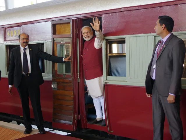 Indian Prime Minister Narendra Modi, waves from a train carriage at Pentrich Railway station in Pietermaritzburg, South Africa, Saturday July 9, 2016. Narendra Modi is taking the same historic train trip that Mahatma Gandhi took in 1893 when he was thrown off the train because of his race. Modi is on a four nation trip to Africa. (Photo by AP Photo/Stringer)