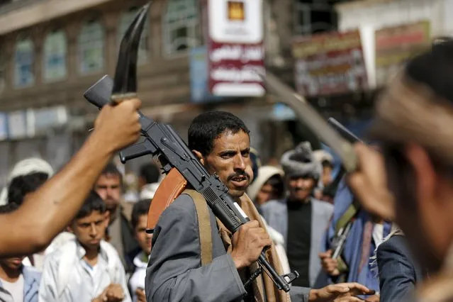 A Houthi follower carries his rifle as he dances with others the traditional Baraa dance ahead of a demonstration against the Saudi-led air strikes in Yemen's capital Sanaa August 24, 2015. (Photo by Khaled Abdullah/Reuters)