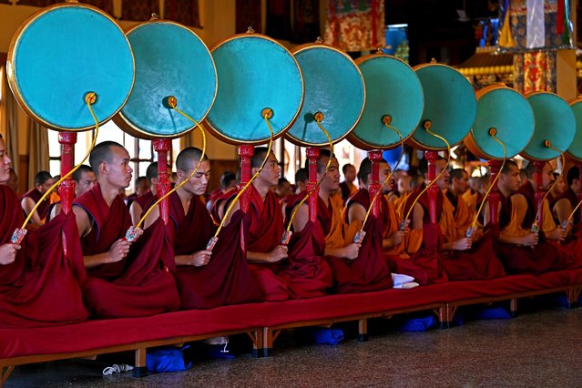 Buddhist monks play drums during morning prayers at Gyuto Monastery in Dharamsala, India on October 11, 2023. (Photo by Arun Sankar/AFP Photo)