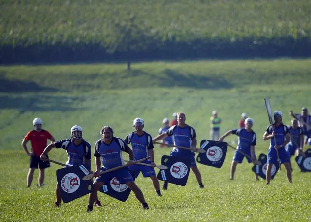 Hornussen players watch out for the nouss during a game of the Swiss Federal Hornussenn festival in Limpach, Switzerland, August 30, 2015. (Photo by Ruben Sprich/Reuters)