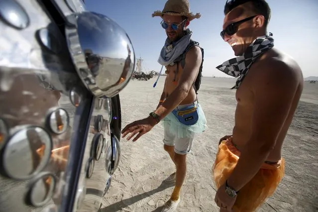 Dan Landers (L) and Tom Kelshaw interact with the art installation Compound Eye during the Burning Man 2015 “Carnival of Mirrors” arts and music festival in the Black Rock Desert of Nevada, August 31, 2015. (Photo by Jim Urquhart/Reuters)