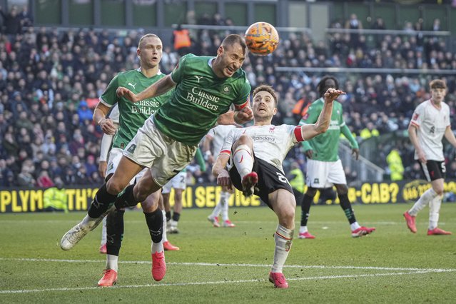 Plymouth Argyle's Nikola Katic, left, clears the ball next to Liverpool's Diogo Jota during the English FA Cup fourth round soccer match between Plymouth Argyle and Liverpool at Home Park stadium in Plymouth, England, Sunday, February 9, 2025. (Photo by Alastair Grant/AP Photo)