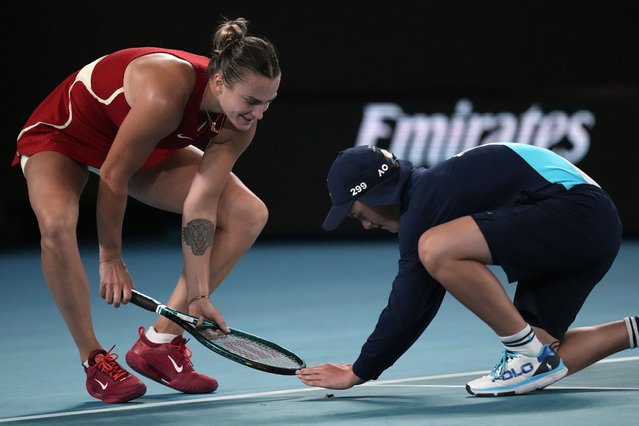 Aryna Sabalenka of Belarus helps a ball kid catch an insect during her quarterfinal against Barbora Krejcikova of the Czech Republic at the Australian Open tennis championships at Melbourne Park, Melbourne, Australia, Tuesday, January 23, 2024. (Photo by Louise Delmotte/AP Photo)