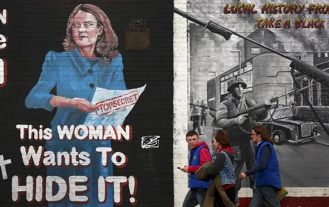 People walk past a mural on the Falls road in Belfast depicting Britain's Northern Ireland Secretary of State Theresa Villiers, September 15, 2015. Theresa Villiers proposed the creation of an independent watchdog to monitor paramilitary organisations in Northern Ireland after a shooting linked to the Irish Republican Army (IRA) threatened to unravel a two-decade old peace deal. (Photo by Cathal McNaughton/Reuters)