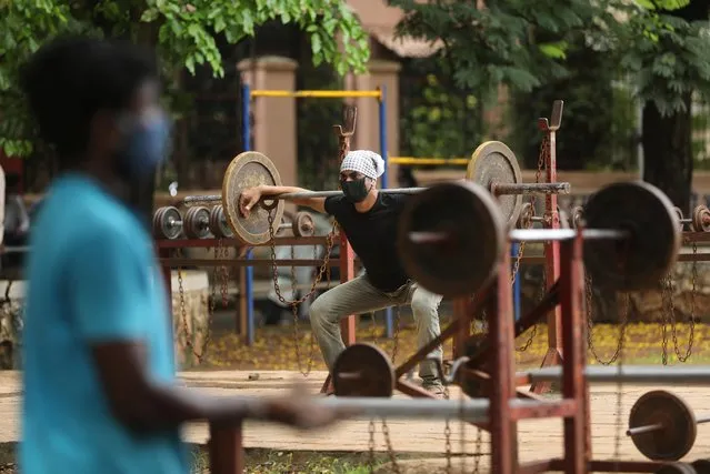 A man lifts weights at an open air gym at a park after a few restrictions were relaxed during a lockdown to slow the spread of the coronavirus disease (COVID-19), in Mumbai, India, June 20, 2020. (Photo by Francis Mascarenhas/Reuters)