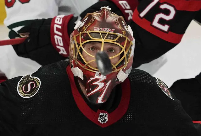 Ottawa Senators goaltender Anton Forsberg keeps his eye on the puck during the second period of an NHL hockey game against the Minnesota Wild, Thursday, October 27, 2022 in Ottawa, Ontario. (Photo by Adrian Wyld/The Canadian Press via AP Photo)