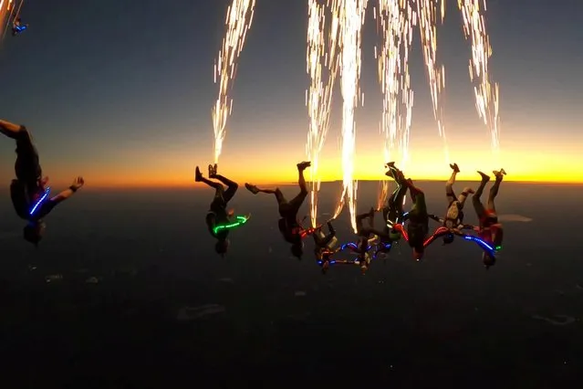 A skydiving instructor and friends attached pyrotechnics to their shoes and LEDs to their bodies before jumping from a plane in Rosharon, Texas on July 1, 2020. (Photo by Mark Wallace/South West News Service)