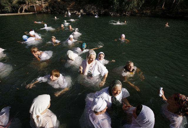 Christian pilgrims bath in the Jordan River near the northern Israeli city of Tiberias during a Baptism ceremony September 6, 2010. (Photo by Baz Ratner/Reuters)