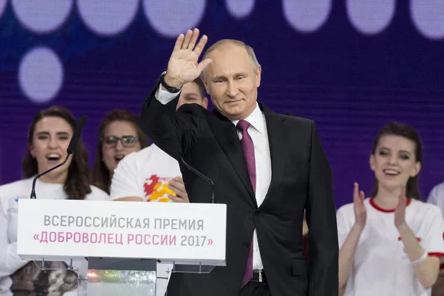 Russian President Vladimir Putin gestures as he speaks at the annual Volunteer of Russia 2017 award ceremony at the Megasport Sport Palace in Moscow, Russia, Wednesday, December 6, 2017. Putin has moved an inch closer to announcing his intention to seek re-election in the next March's vote, saying he would weigh the move based on public support. (Photo by Ivan Sekretarev/AP Photo)
