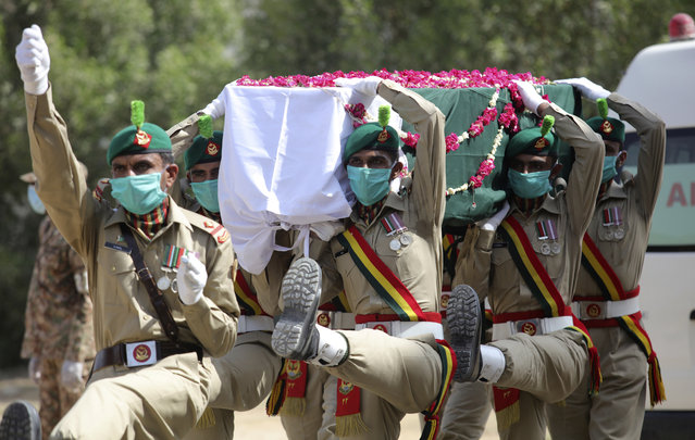 In this June 1, 2020, file, photo, Pakistani soldiers carry the coffin of their colleague who died in the crash of a state-run Pakistan International Airlines plane May 22, during his funeral in Karachi, Pakistan. The European Union’s aviation safety agency said Tuesday, June 30, 2020 that Pakistan’s national airline will not be allowed to fly into Europe for at least six months after the country’s aviation minister revealed that nearly a third of Pakistani pilots had cheated on their pilot’s exams. (Photo by Fareed Khan/AP Photo/File)