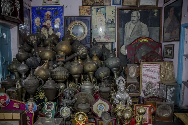 In this November 20, 2017 photo, photographs and trophies belonging to Indian Kushti wrestlers are seen inside the office of Guru Hunuman Akhada, one of India's oldest akhadas at Sabzi Mandi, in New Delhi, India. (Photo by Dar Yasin/AP Photo)