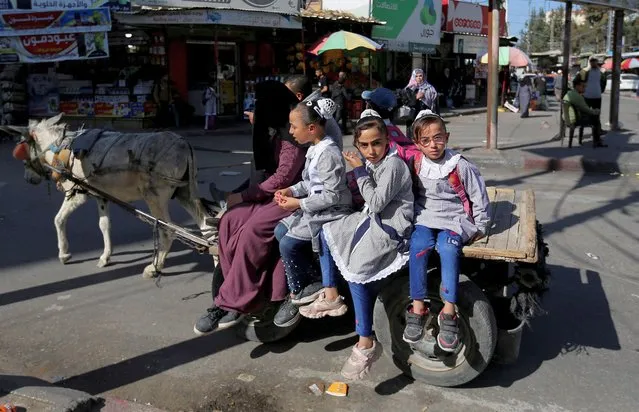 Children sit on a carriage after returning from school, following a twin blast in Jerusalem, in Rafah in southern Gaza Strip on November 23, 2022. (Photo by Ibraheem Abu Mustafa/Reuters)